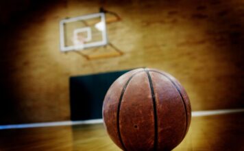 Basketball auf dunklem Spielfeld als Symbol für den NBA-Skandal um Pokerbetrug und Insiderwetten