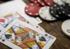 Slide Dealing im Venetian: Schutz vor Kameras, Streit ums Tempo Spielkarten und Casino-Chips auf einem Holztisch, inklusive eines Dealer-Buttons
